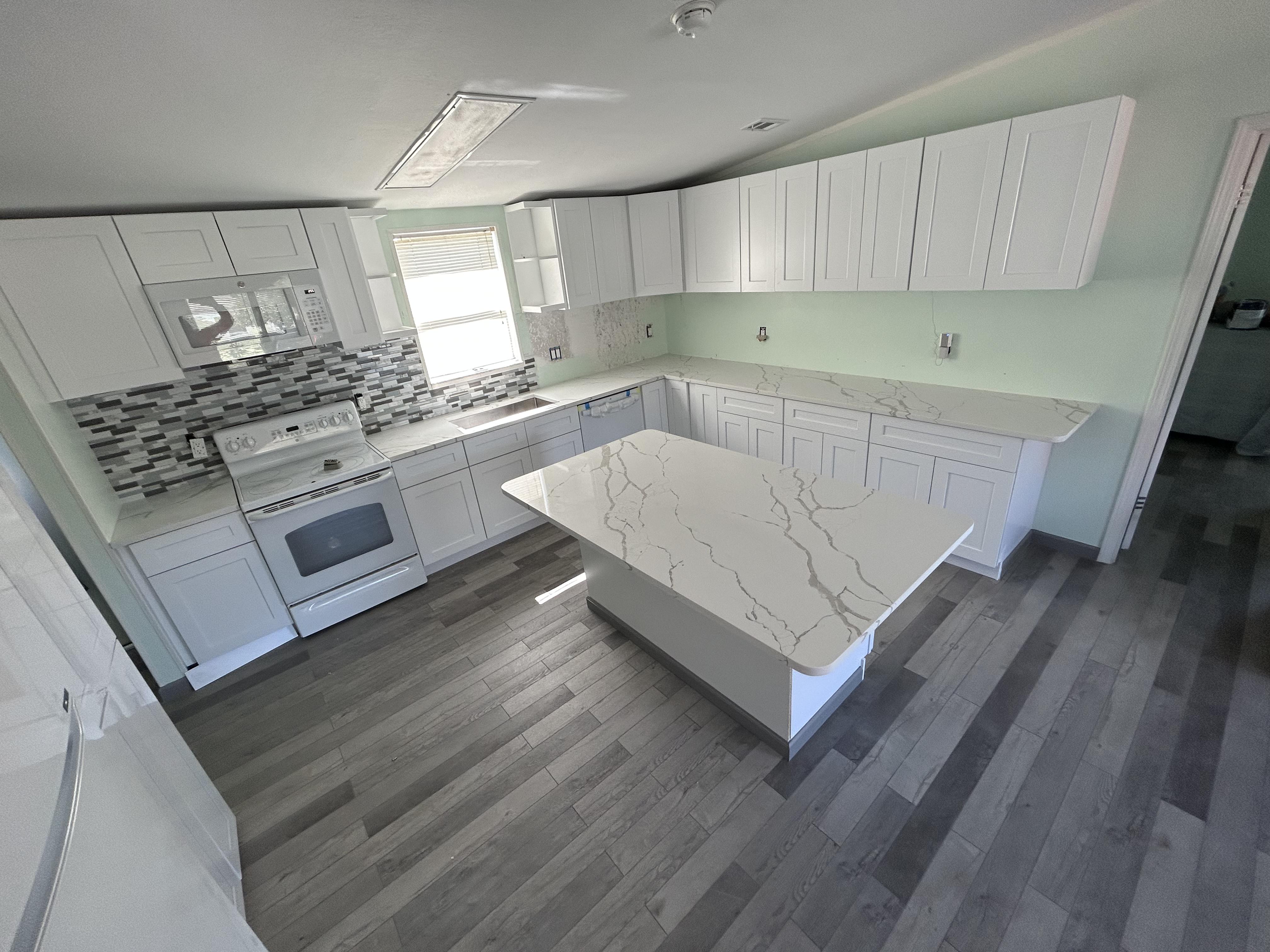 Modern white kitchen with veined quartz