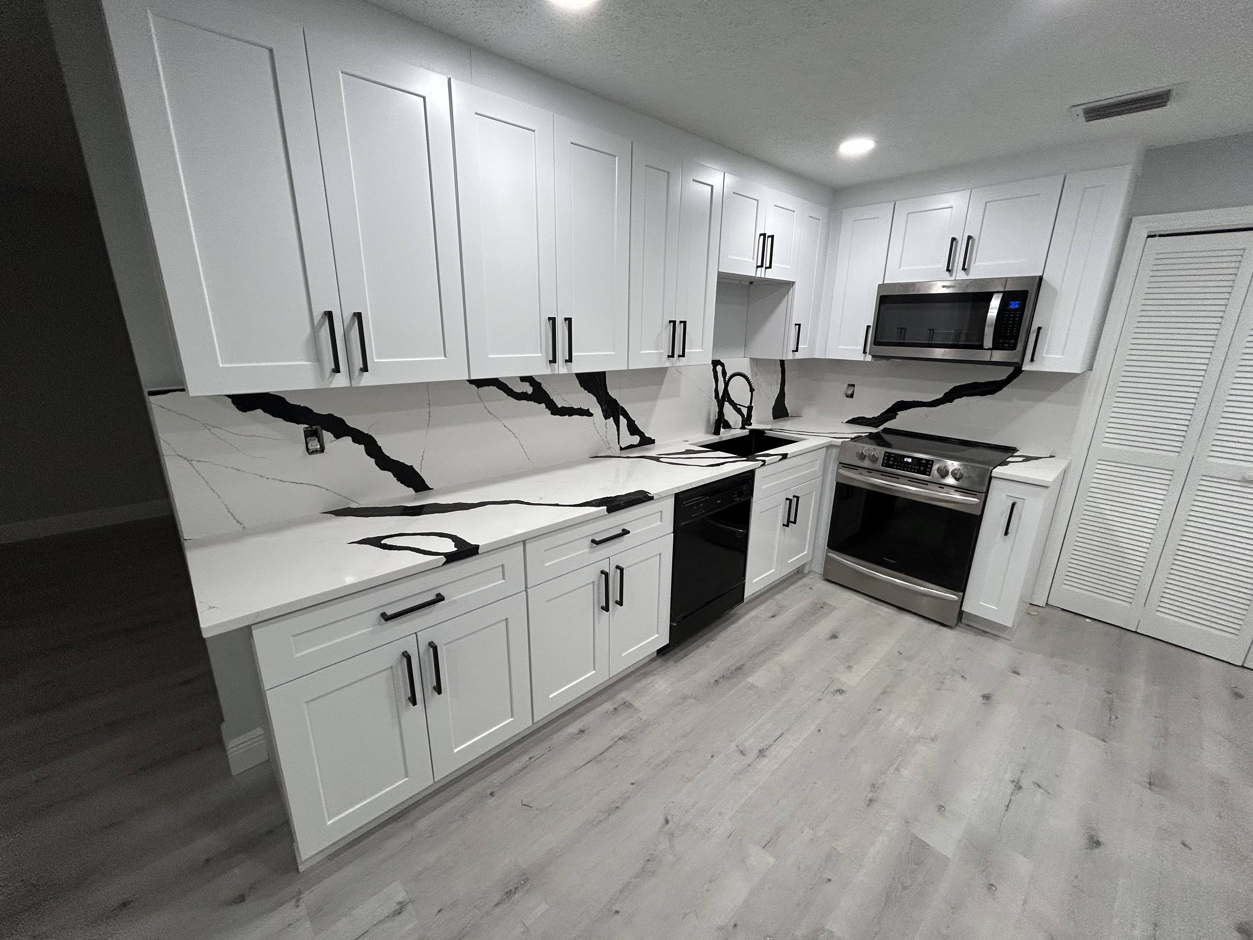 Sleek kitchen with matching veined backsplash